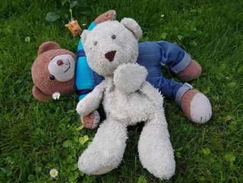 High angle view of teddy bears on grassy field