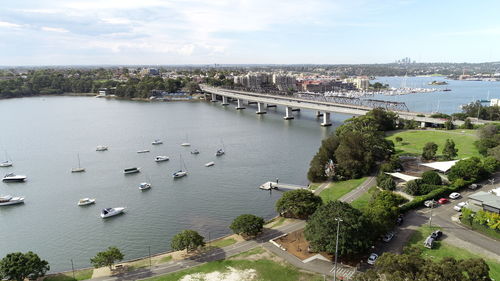 High angle view of bridge over river in city against sky