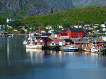 Scenic view of fjord by buildings