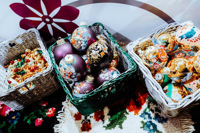 Wicker baskets with christmas toys balls with winter design. christmas tree and new year atmosphere