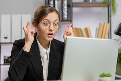 Businesswoman using laptop at office