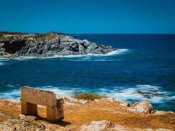 Scenic view of sea against clear blue sky