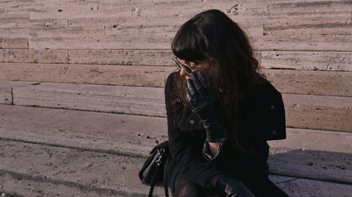 Beautiful girl sits on the stairs in rome 