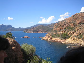 Scenic view of sea and mountains against sky