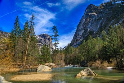 Scenic view of river amidst mountains against sky