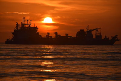 Scenic view of sea against orange sky