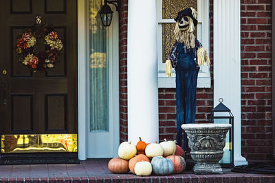 Rear view of woman sitting in front of house