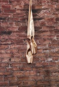 Close-up of clothes hanging on brick wall