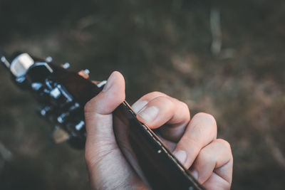 Close-up of hand holding guitar