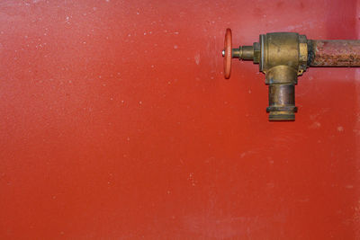 Close-up of water faucet against wall