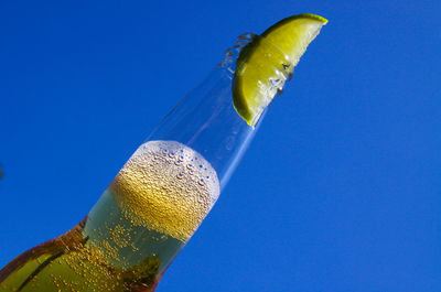 Close-up of drink against blue sky