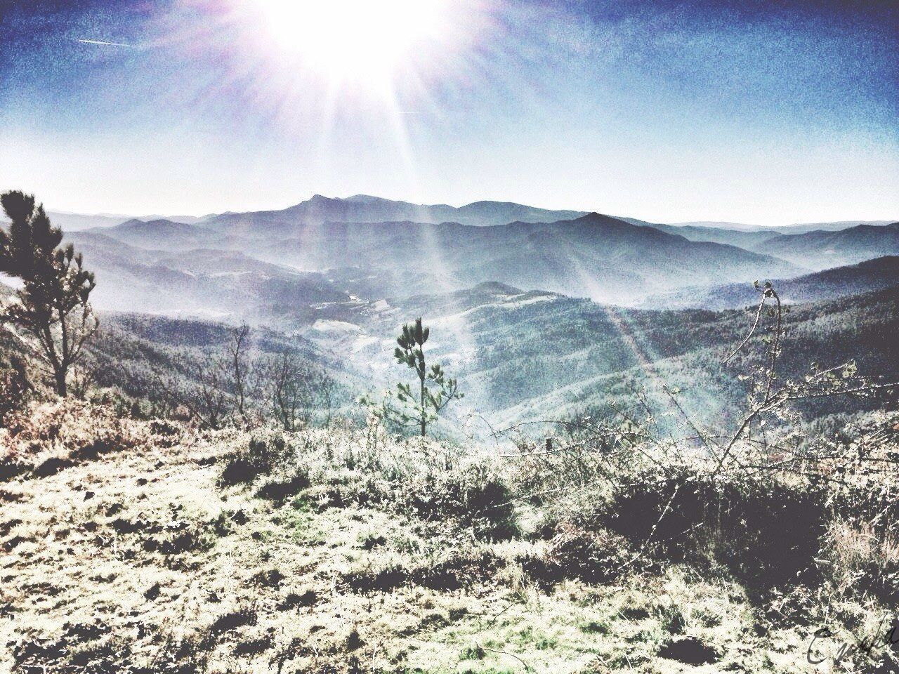 sun, sunlight, tranquility, sunbeam, tranquil scene, mountain, scenics, beauty in nature, landscape, lens flare, nature, sunny, sky, mountain range, non-urban scene, day, bright, idyllic, remote, clear sky