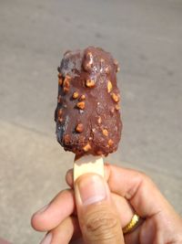 Close-up of hand holding ice cream cone