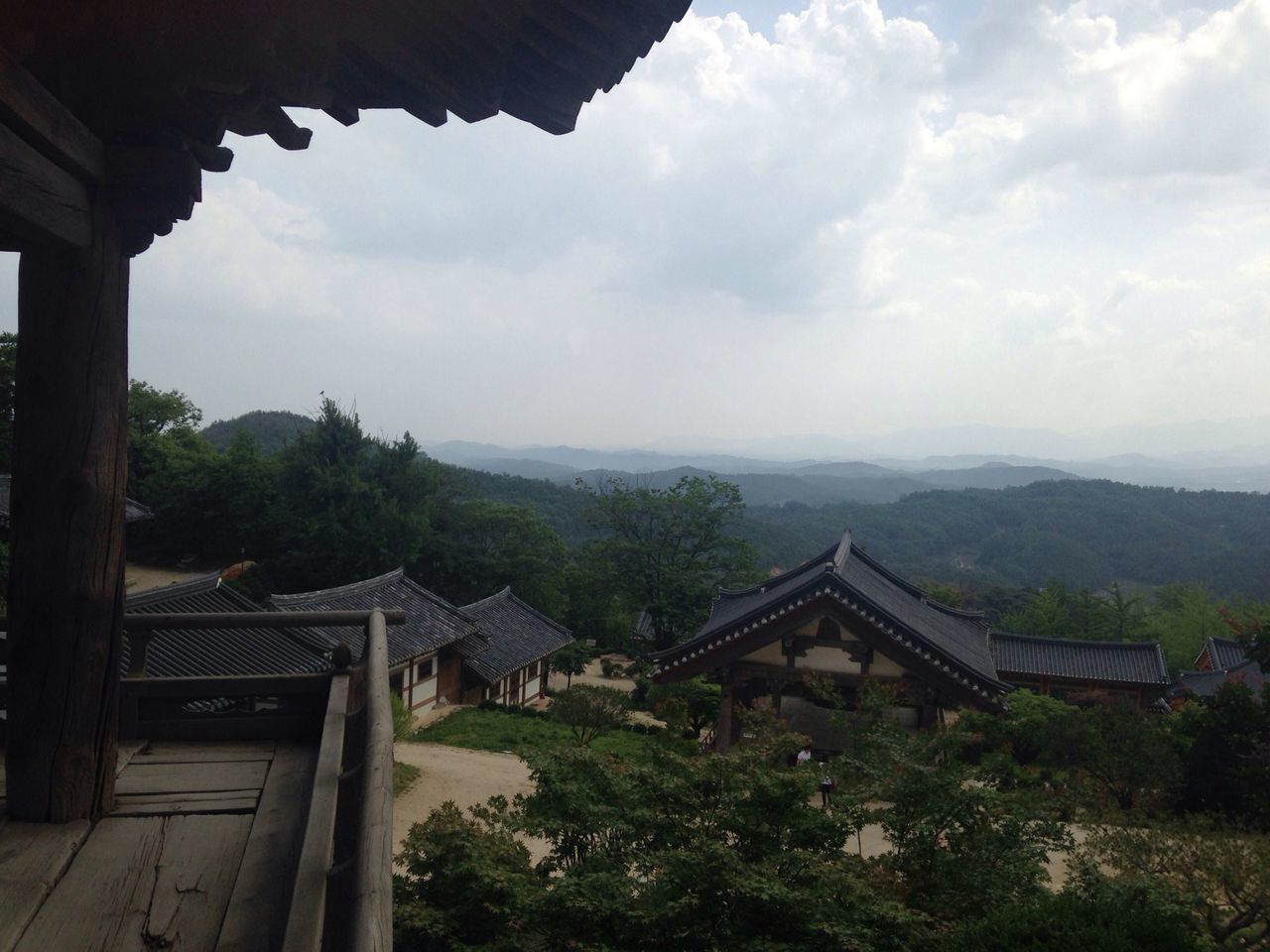 built structure, architecture, sky, building exterior, cloud - sky, place of worship, mountain, religion, spirituality, temple - building, cloud, tree, history, house, roof, day, travel destinations, nature, cloudy, tranquility