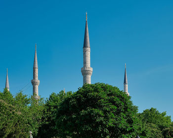 Low angle view of building against clear blue sky