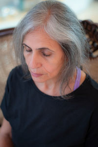 Close-up of senior woman with eyes closed at home