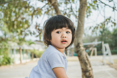 Cute girl playing on slide at park