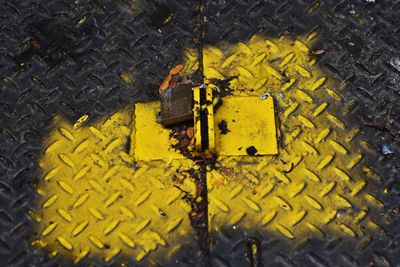 Close-up of yellow puddle on street