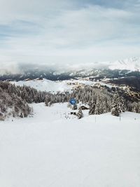 Scenic view of snow covered land against sky