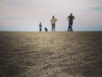 People standing on ground against sky