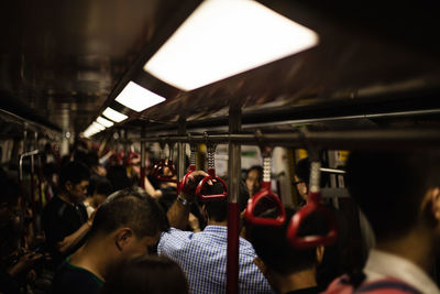 View of crowd in illuminated subway train