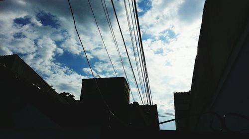 Low angle view of building against cloudy sky