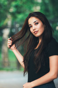 Portrait of a beautiful young woman standing outdoors