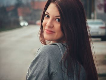 Portrait of beautiful woman standing at street