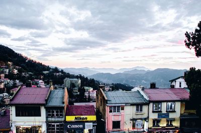 Houses in city against sky