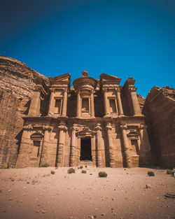 Low angle view of old building against blue sky