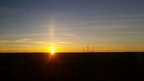 Silhouette of electricity pylon against sky during sunset