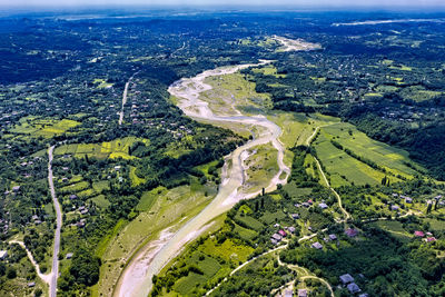 High angle view of road amidst trees in city