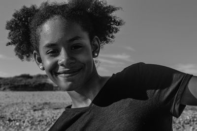 Close-up portrait of smiling teenage girl with curly hair