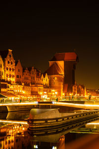 Old town in gdansk at night. the riverside on granary island reflection in moltawa river cityscape