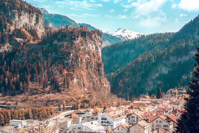 High angle view of townscape by mountains