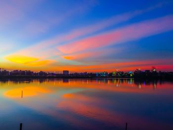 Scenic view of lake against romantic sky at sunset