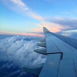 Cropped image of airplane against blue sky