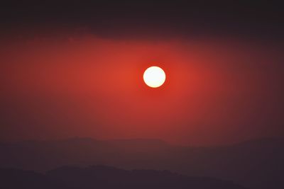 Scenic view of silhouette moon against sky during sunset