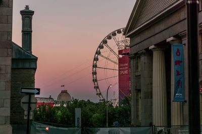 Buildings in city against sky during sunset