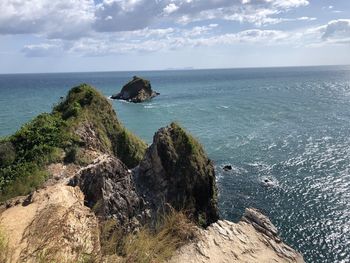 Scenic view of rocks in sea against sky