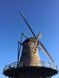 Low angle view of traditional windmill against clear sky