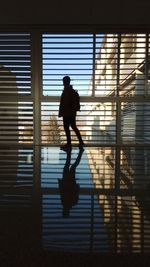 Silhouette man walking in corridor