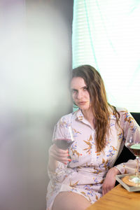 Young woman sitting with ice cream