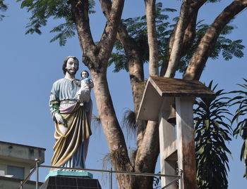 Low angle view of statue against sky