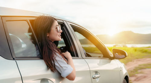 Woman looking through car window