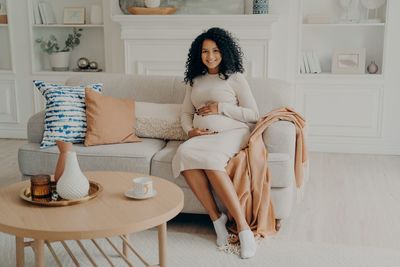 Woman sitting on sofa at home