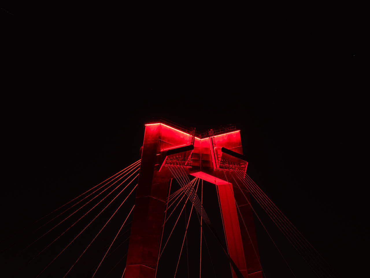 LOW ANGLE VIEW OF ILLUMINATED CHRISTMAS LIGHTS AGAINST SKY