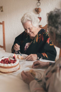 Side view of woman holding food at home