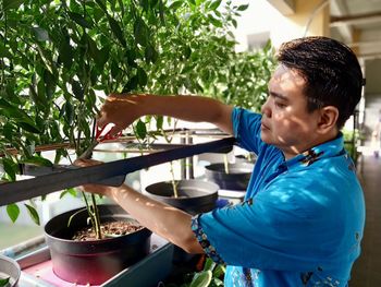 Side view of a man holding food
