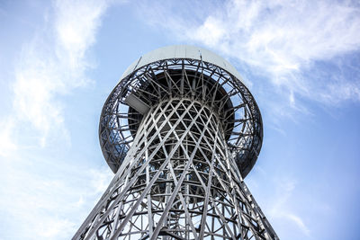 Low angle view of communications tower against sky